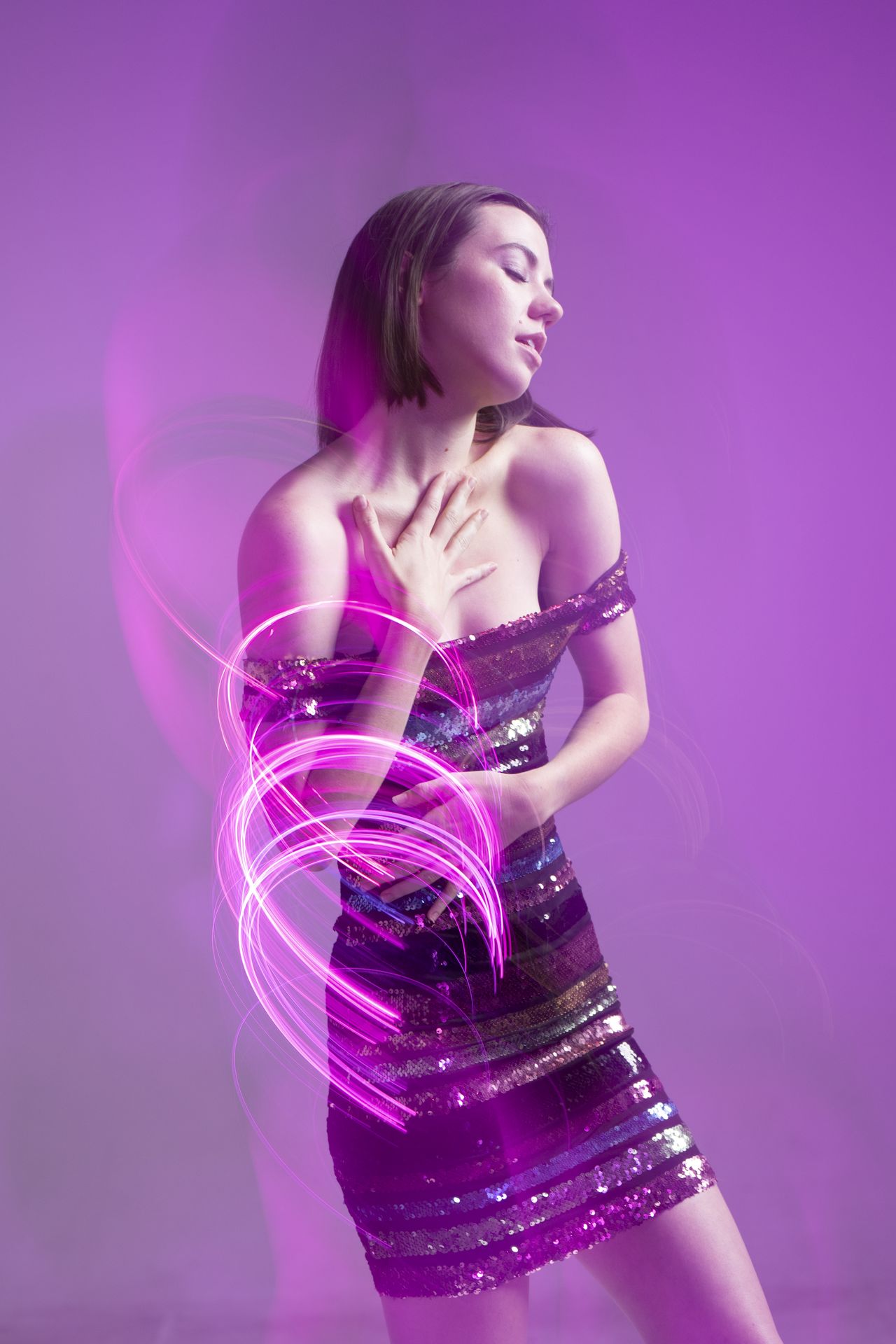 Model in sequin dress with neon lights